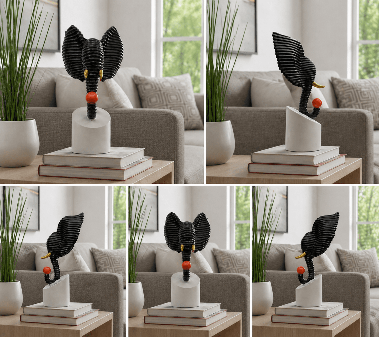 Abstract black textured elephant head sculpture holding a red ball, displayed on a modern living room side table over decorative books preview 6